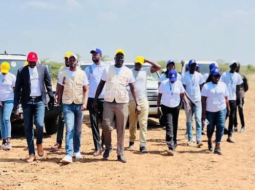 Community members and HWISS staff gathered during a field program